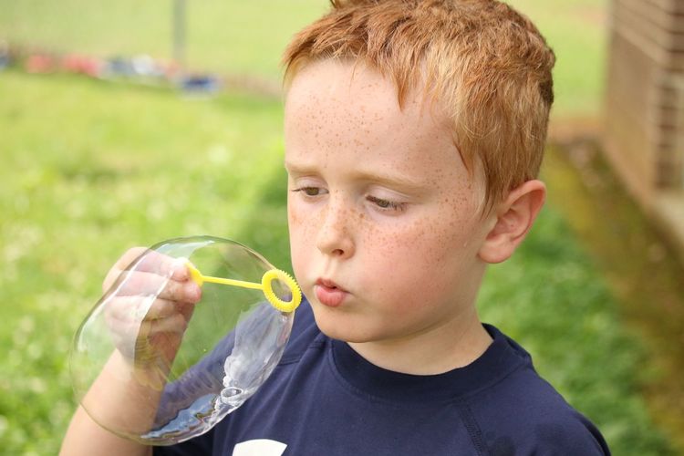Portrait of boy drinking outdoors