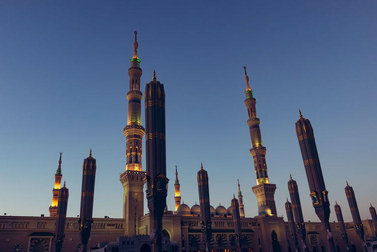 Toned image of a low angle view of nabawi mosque during sunrise in madinah, saudi arabia.