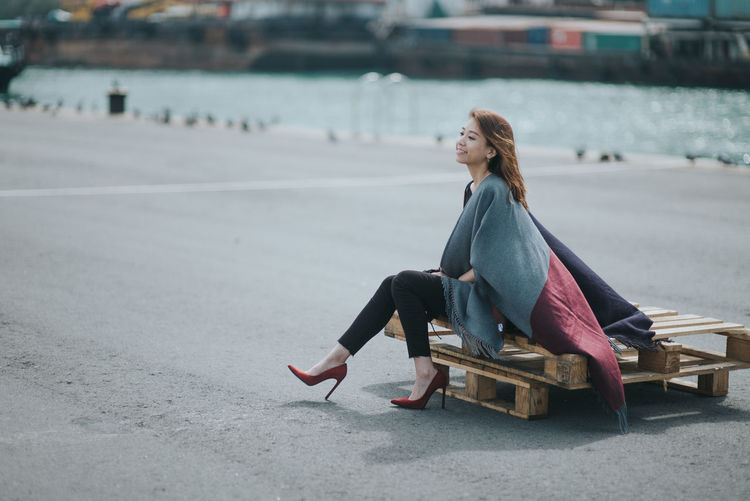 Woman sitting on pallets