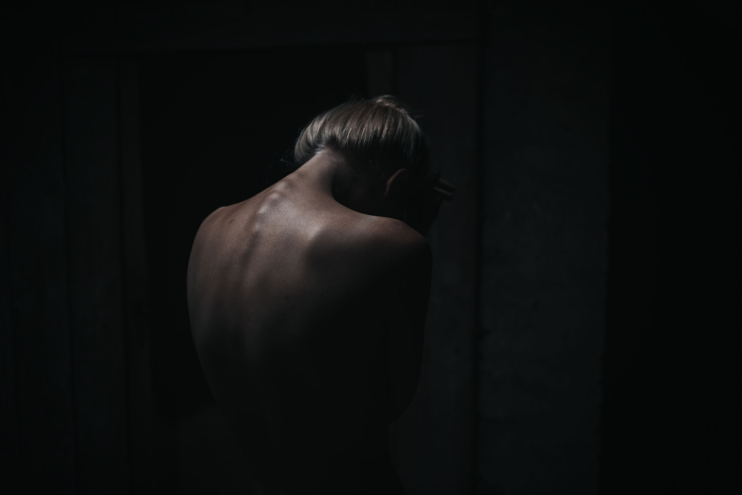 rear view, human back, one person, indoors, shirtless, back, standing, women, lifestyles, domestic room, black background, young adult, day, adult, people