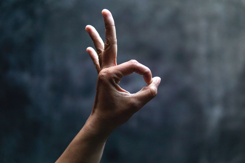 Cropped image of hand gesturing ok sign