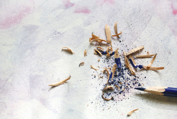 Close-up of sharp colored pencil with shavings