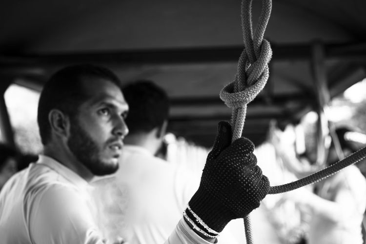 Low angle view of man holding rope