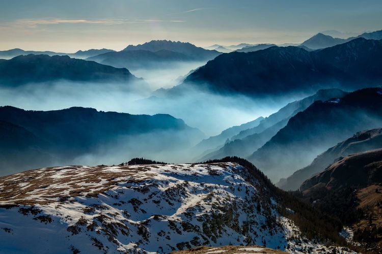 Scenic view of snow covered mountains against sky