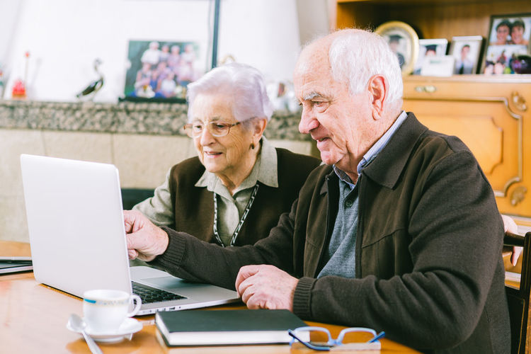 Senior people using laptop at home