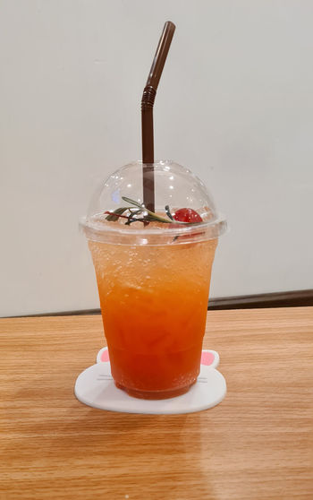 A fruit tea with ice on the table