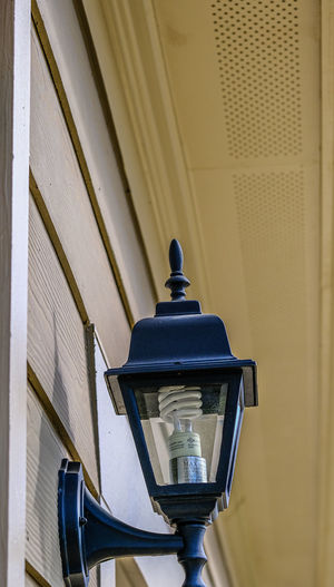 Low angle view of lantern on street light against building