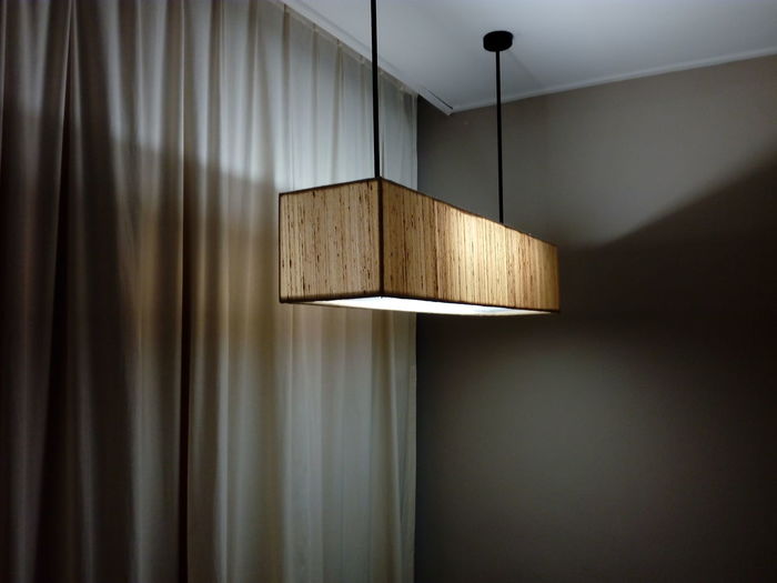 Close-up of illuminated lamp on wall at home