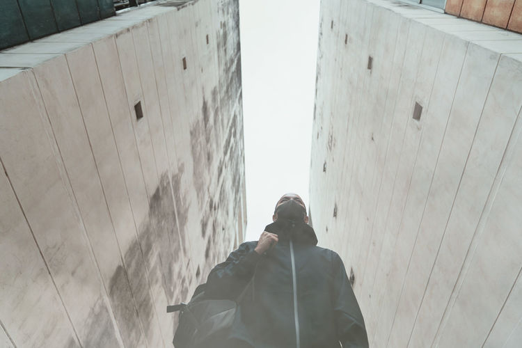 Low angle view of man standing by building