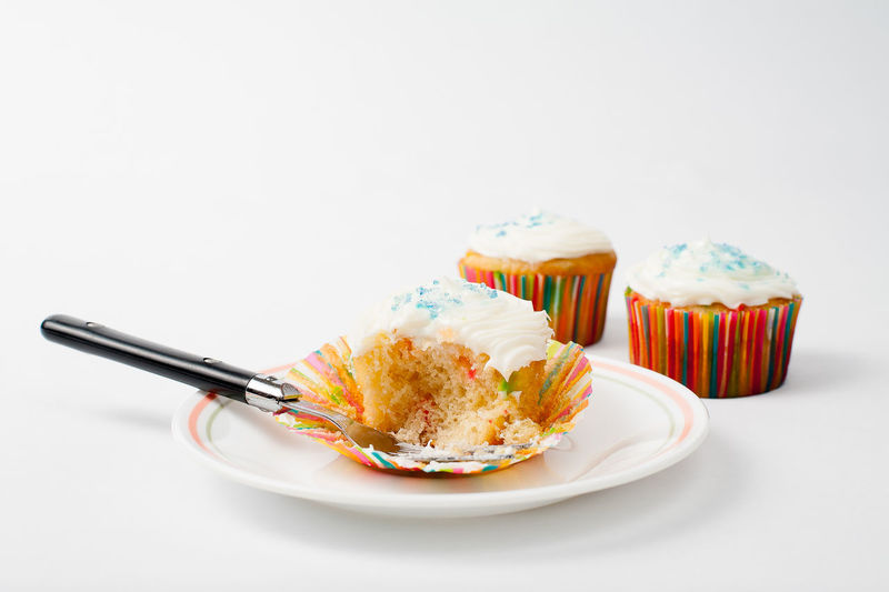 Close-up of cupcakes on table against white background