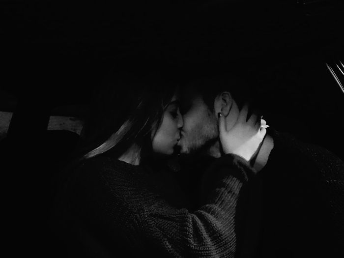 Couple kissing in darkroom
