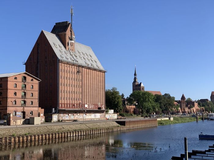 View of buildings in city against clear sky