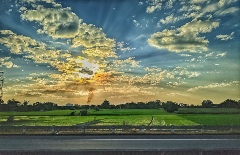 Scenic view of field against sky during sunset