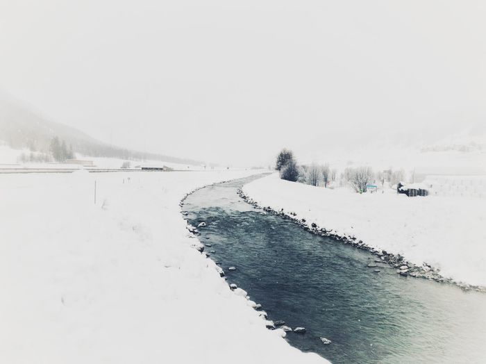 Scenic view of snow covered land against clear sky