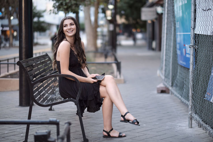 Portrait of smiling woman sitting outdoors