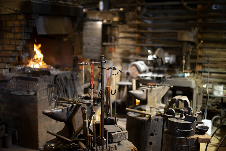 Blacksmith decorative elements hanging at forge, workshop. handmade, craftsmanship and blacksmithing 