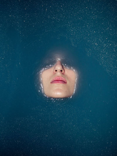 Close-up of woman face in water