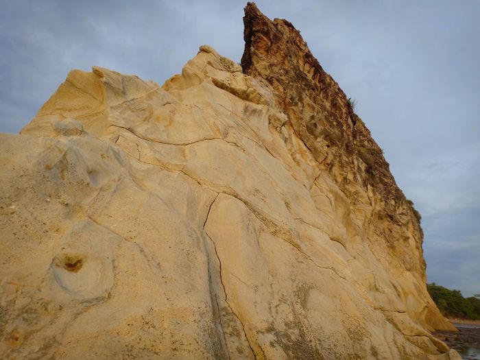 Low angle view of rock formations against sky