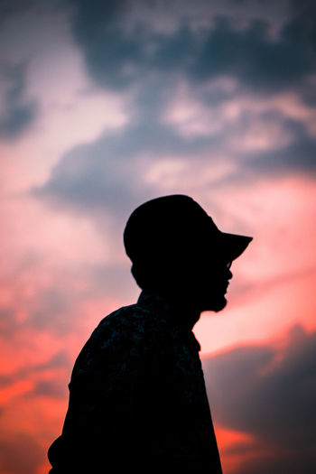 Silhouette of man standing against sky during sunset