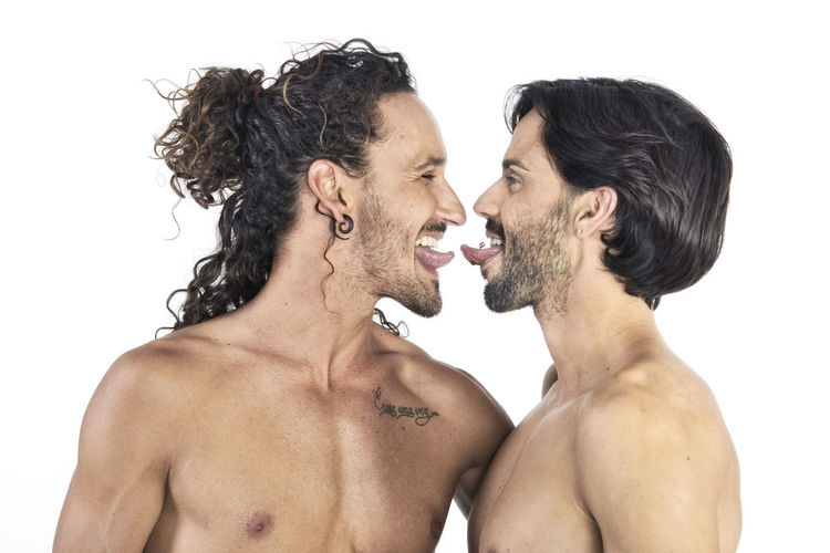 Side view of two people against white background