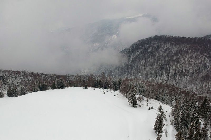 Snow covered landscape against sky