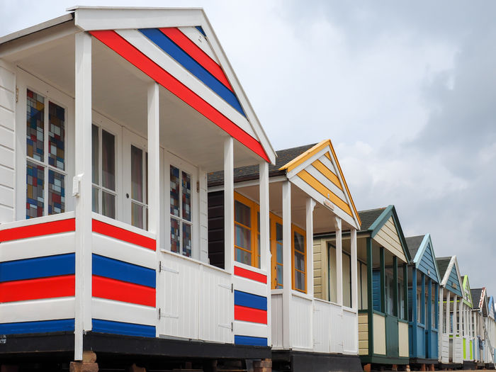 Low angle view of beach huts against buildings