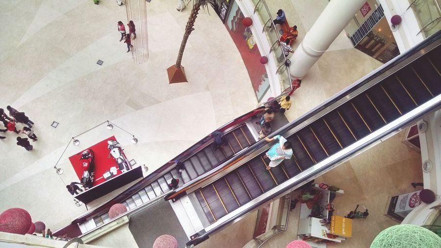 Low angle view of people in shopping mall