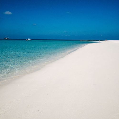 Scenic view of sea against blue sky