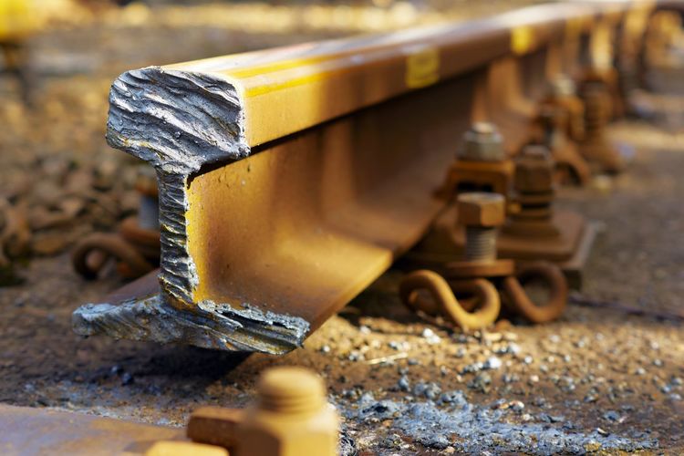Damaged rusty railroad track during sunny day