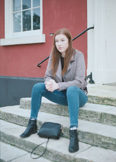 Portrait of young woman sitting outdoors