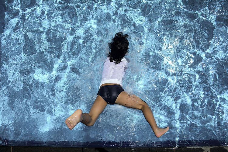 High angle view of woman diving into water