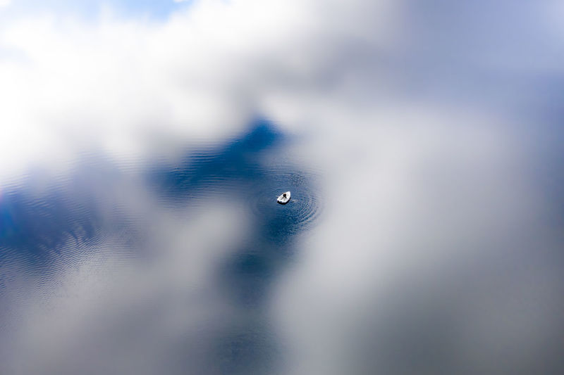 Close-up of water drops against blue sky