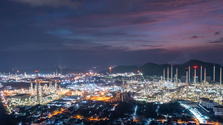 Aerial view of twilight oil refinery and factory petrochemical plant blue sky background, 