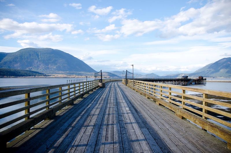 Pier over lake against sky