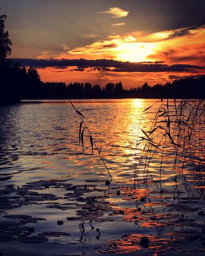 Scenic view of lake against sky during sunset