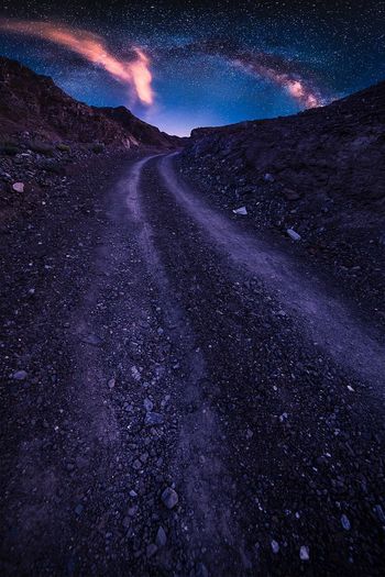 Scenic view of road against sky at night