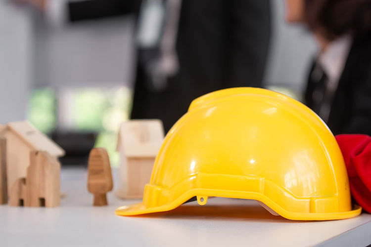 Close-up of yellow hardhat on table
