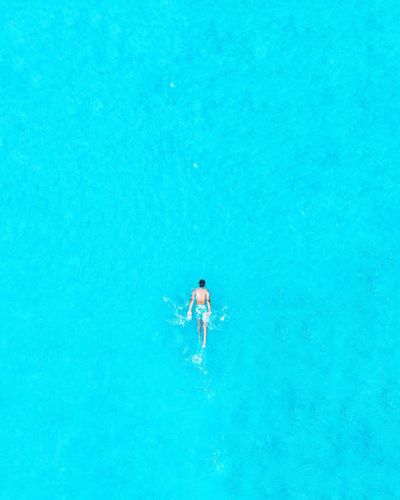 High angle view of man swimming in sea