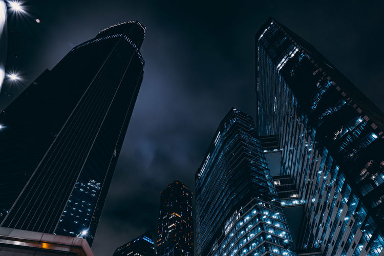 Low angle view of skyscrapers lit up at night