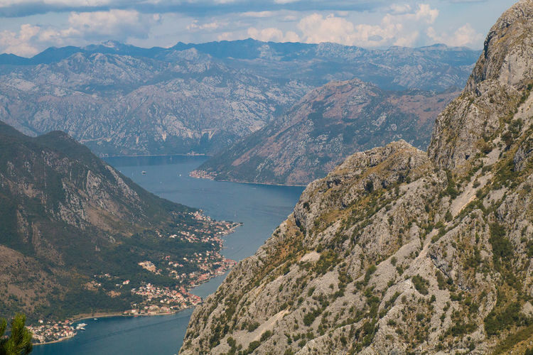 High angle view of sea and mountains against sky