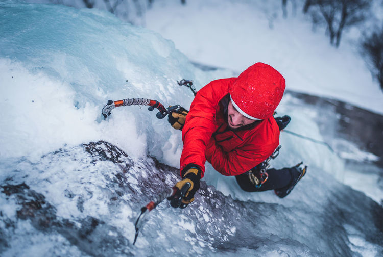 Man ice climbing on cathedral ledge in north conway, new hampshire