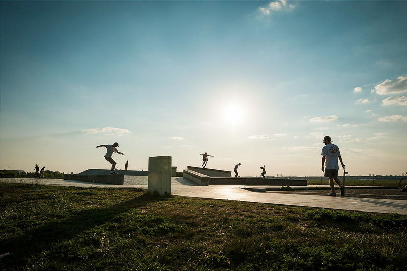 People skateboarding against sky
