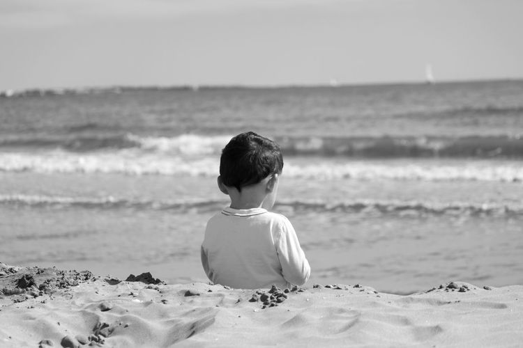 Rear view of boy on beach