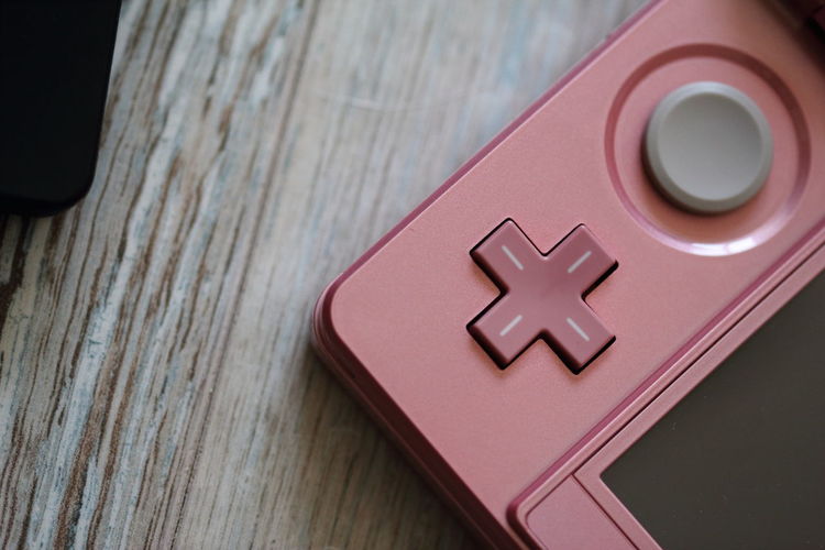 Close-up of pink gamepad on table