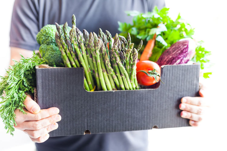 Cropped image of man holding vegetables