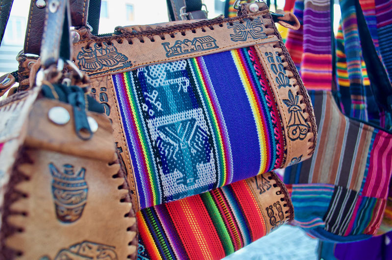 Close-up of sling bags hanging at market stall