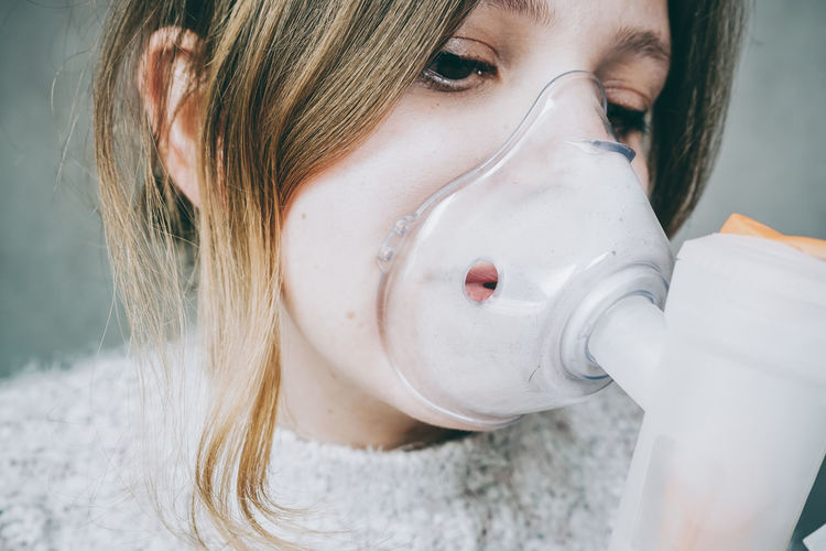 Close-up of woman with breathing equipment