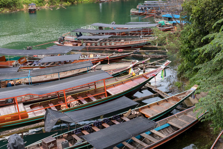 High angle view of long tail boats in water