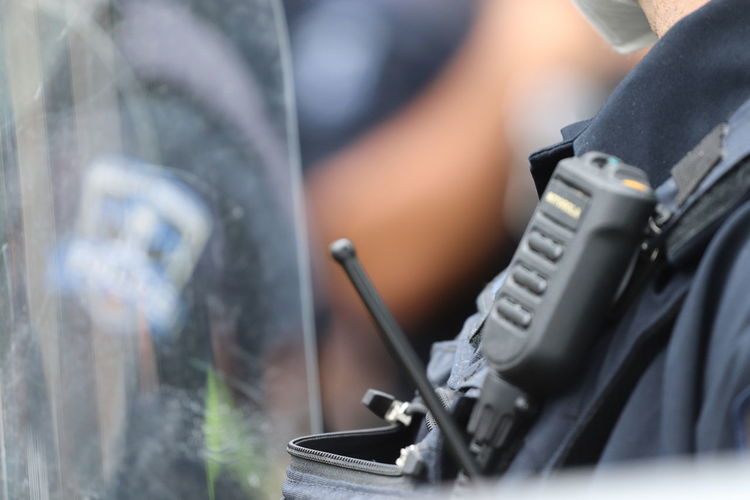 Close-up of police radio during protest 