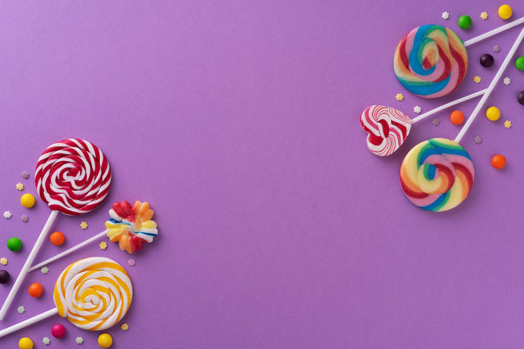 High angle view of multi colored candies against blue background